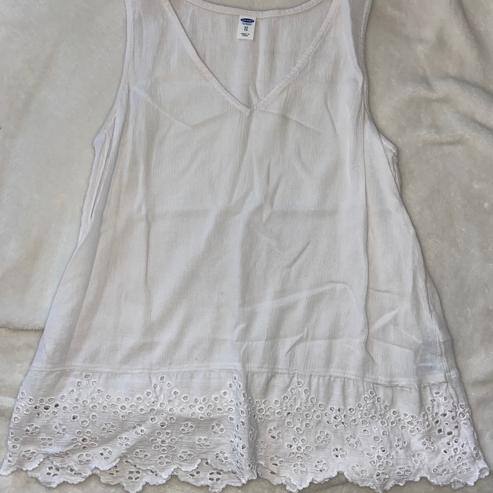 White flowy tank with crochet detail at the bottom